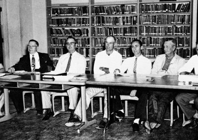1959 Board of Trustees sitting at table in Round Rock HS library